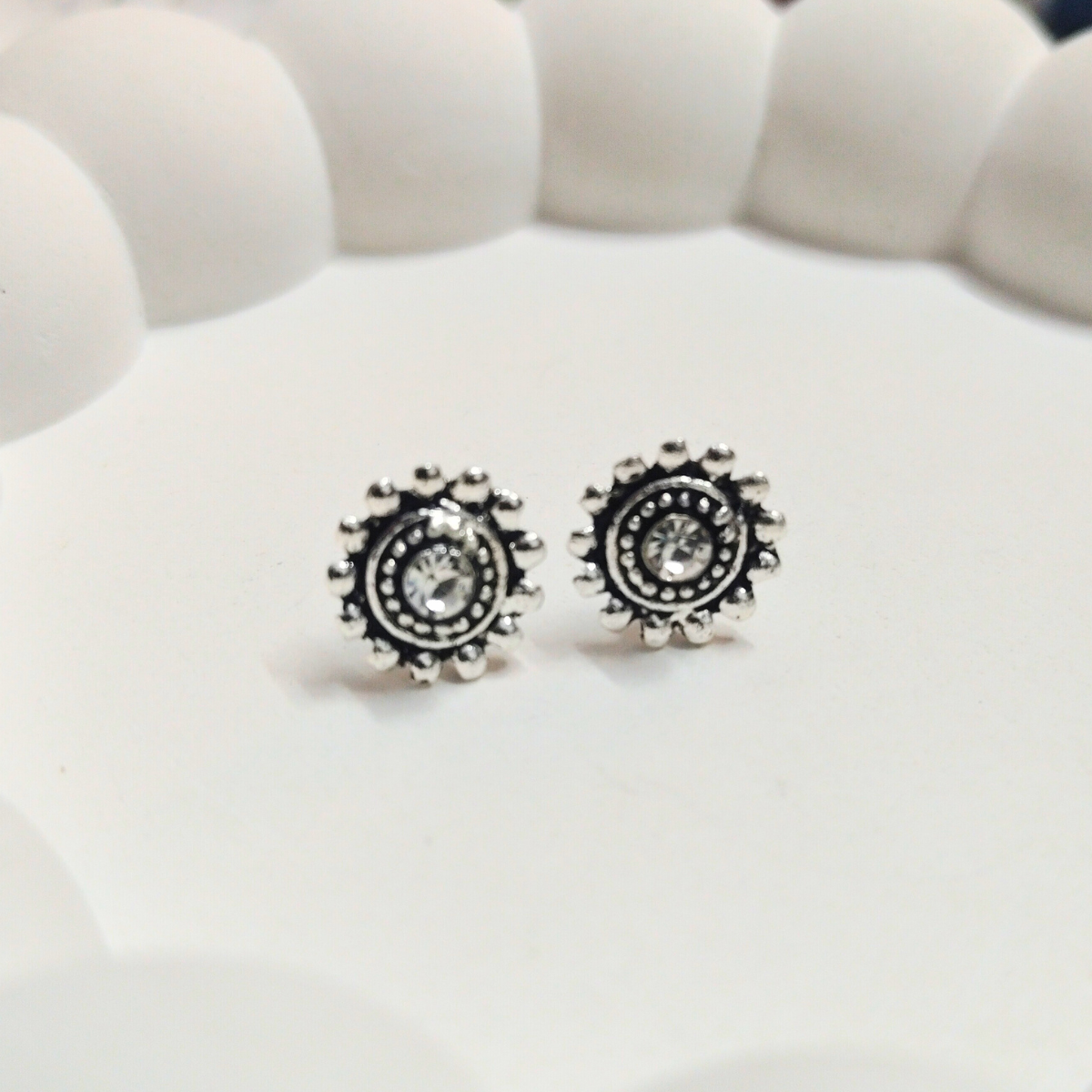 Silver-tone antique circle stud earrings with central crystal detail