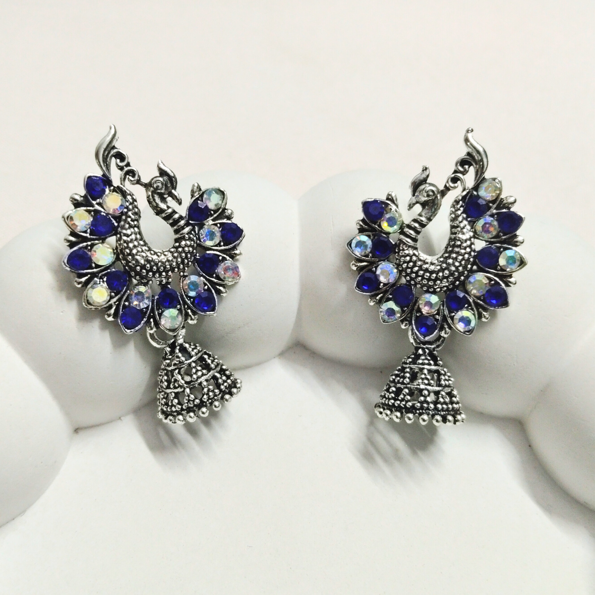 Multi-color peacock jhumka earrings with oxidized finish and stone detailing