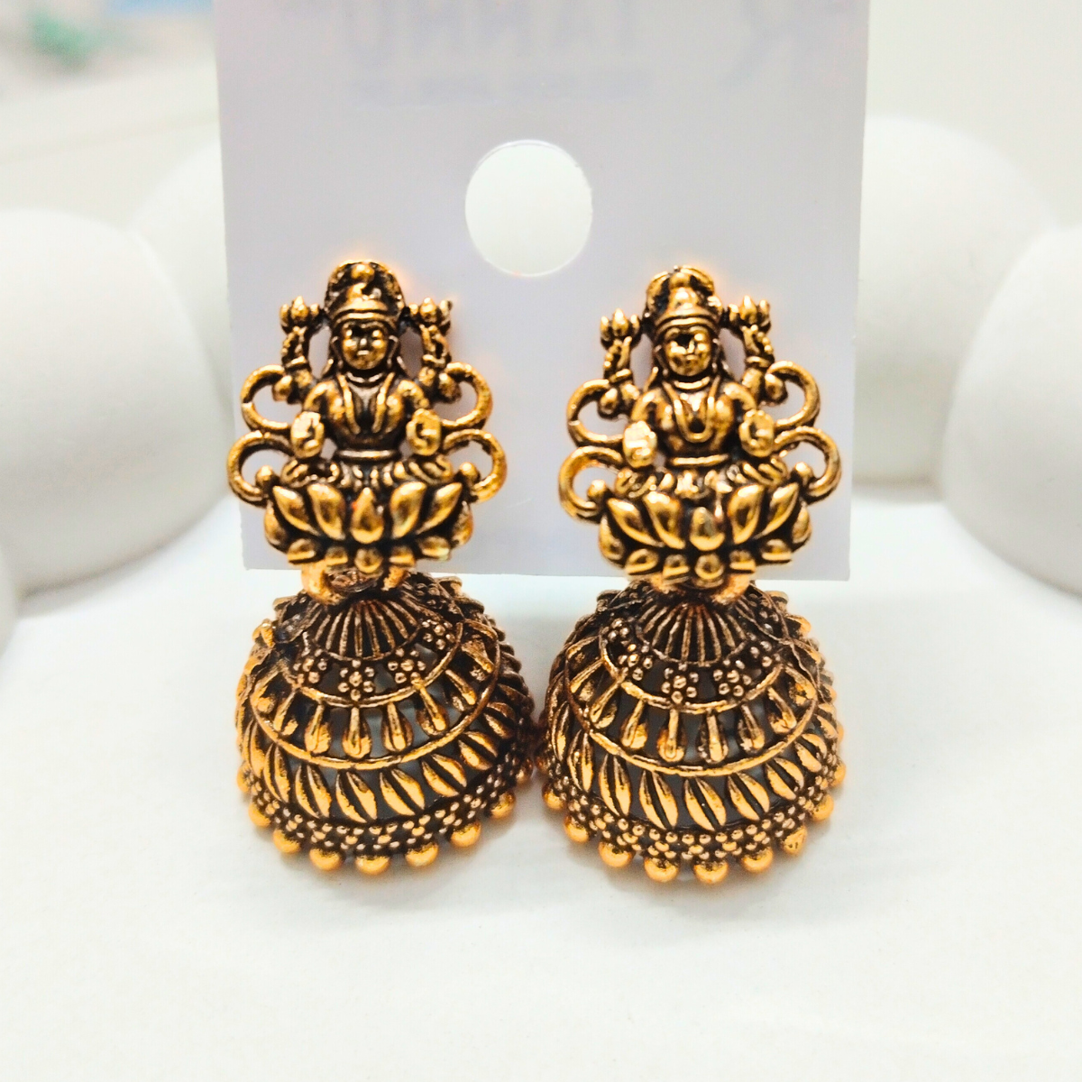 Antique gold Lakshmi temple jhumka earrings, featuring intricate detailing in a traditional design