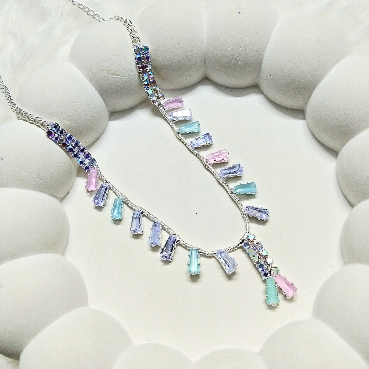 Elegant multicolor stone necklace with pastel pink, blue, and purple crystals on a silver chain