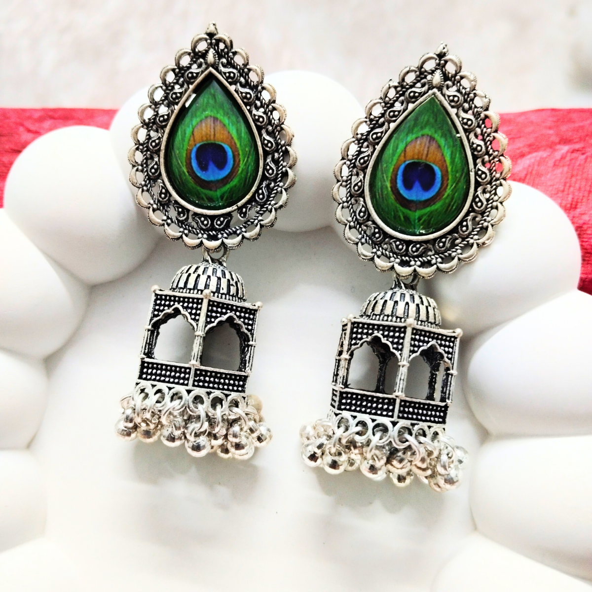 Oxidized dome earrings with teardrop peacock feather design and jhumka detailing