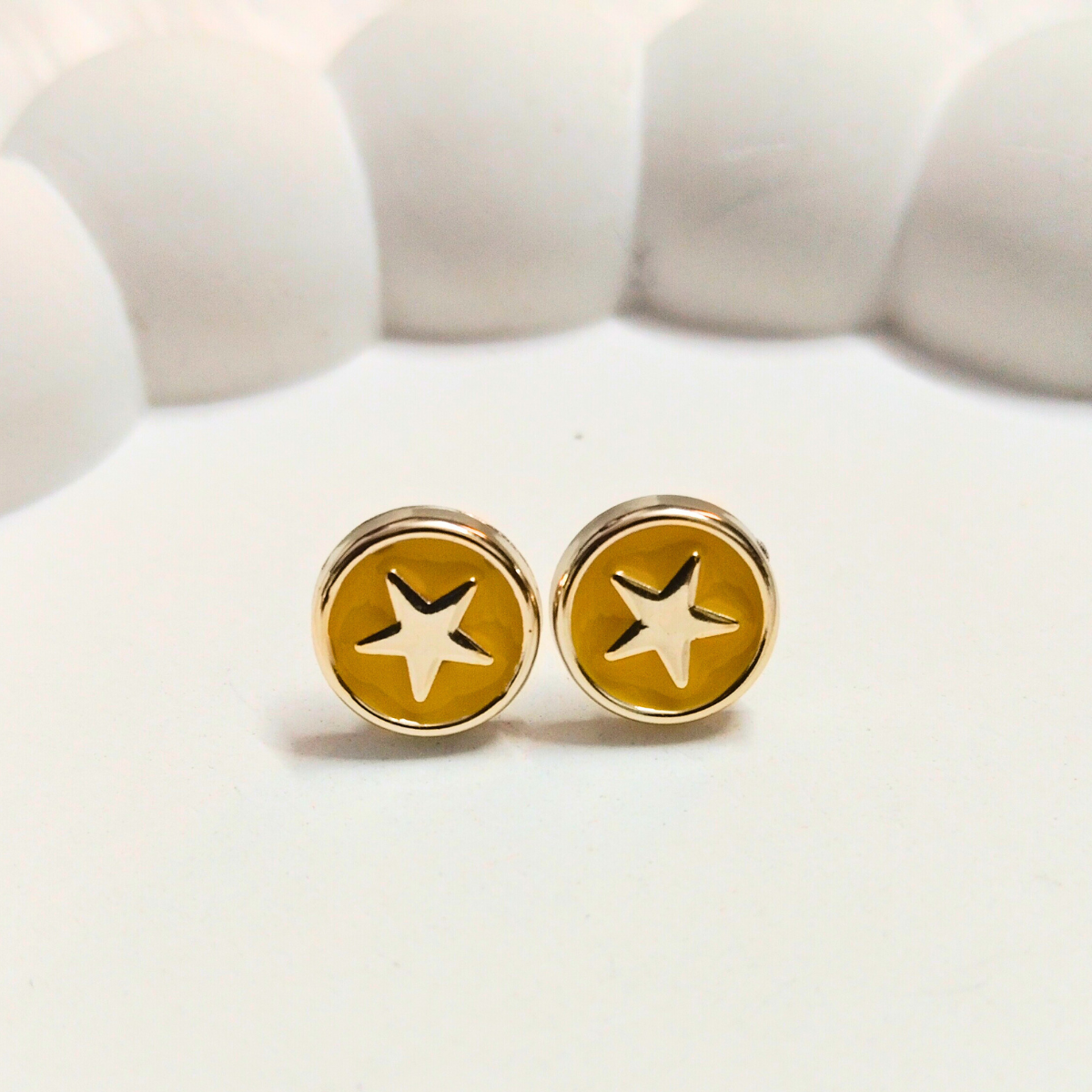 Cute round shaped stud earring with a star designin the middle