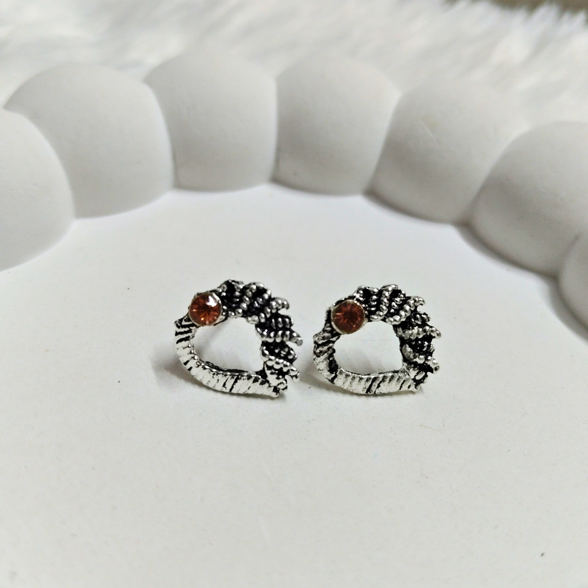 Rustic vintage wreath earrings with burnt orange stone on a white background