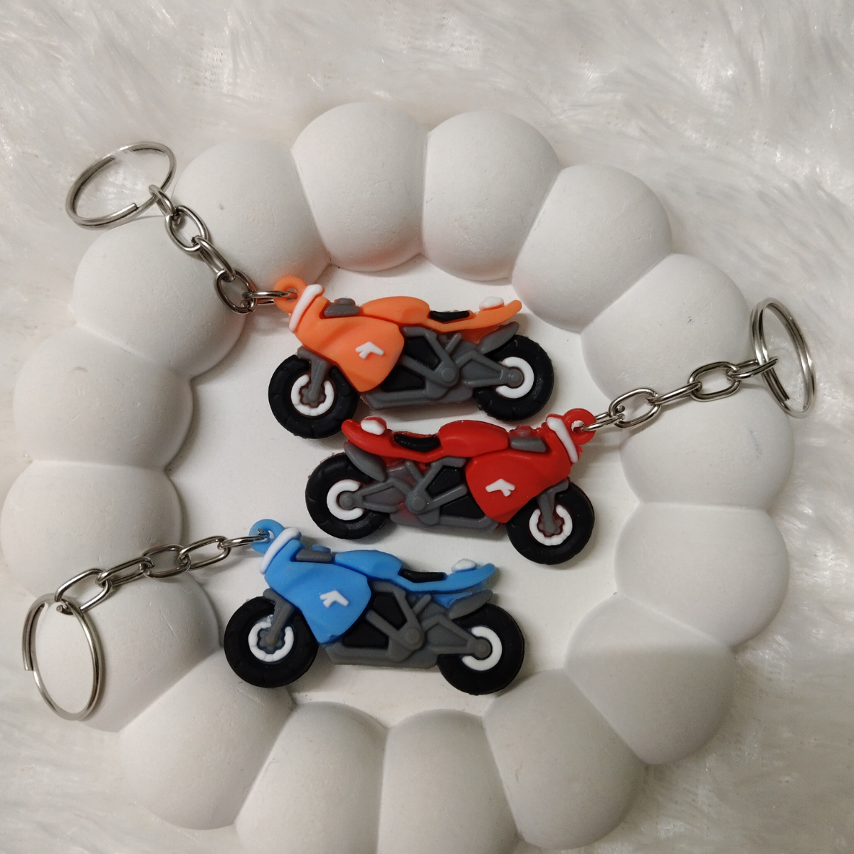 Affordable rubber motorbike keychains in red, orange, and blue – available for just ₹12 with random color selection