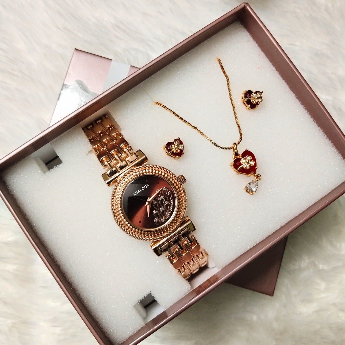 Rose gold analog women's watch with red heart necklace and matching earrings in an elegant gift box.