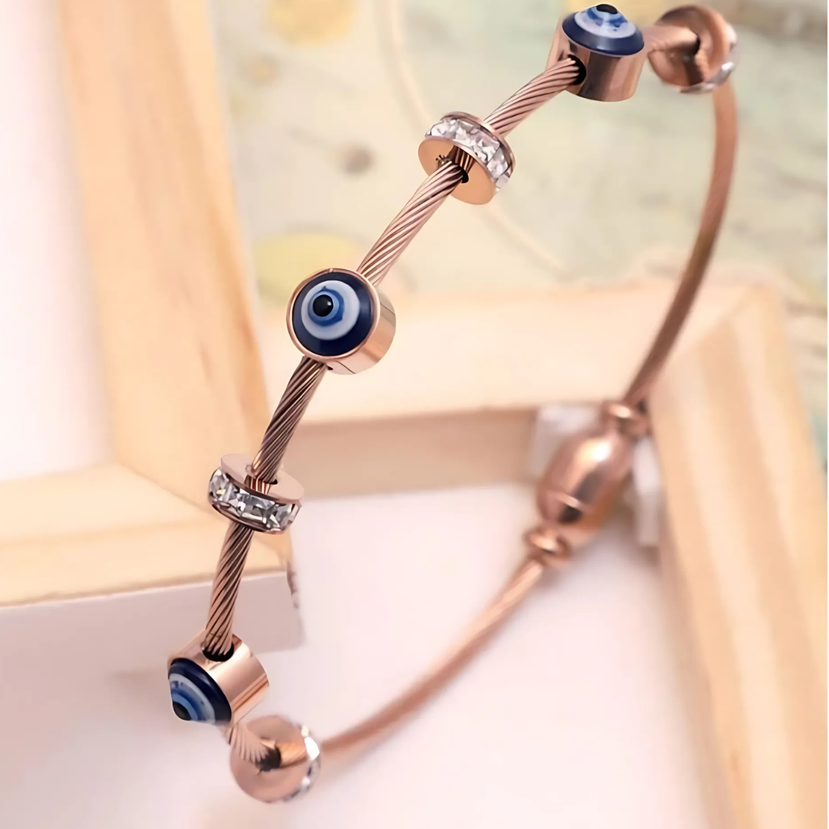 Rose gold cable bracelet with evil eye charms and crystal beads for spiritual protection and style